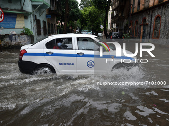 A car is seen moving through a water logged street in Kolkata as many parts of West Bengal including the capital city of Kolkata, witnessed...