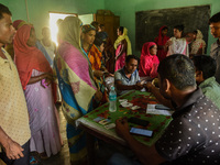 Beneficiaries arrives to get a dose of COVID-19 coronavirus vaccine in a vaccination centre at a village in Barpeta, Assam, India on 20 Sept...