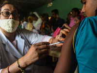 Beneficiaries receives dose of COVID-19 coronavirus vaccine in a vaccination centre at a village in Barpeta, Assam, India on 20 September 20...