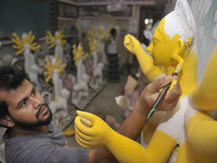 Artist Gourango Paul paints a sculpture of Goddess Durga Idols as part of preparation for the upcoming Hindu religious Durga Puja festival....