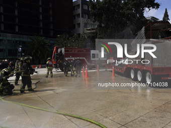   Firefighters extinguish fire to demonstrate to people the precautions to take during a 7.1 earthquake  during   the Earthquake Mega Drill...