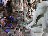 An artisan from Bangla Bazar sculpting a statue of Durga Puja Idol during the Preparations for Hindu Festival of Durga Puja are underway. On...