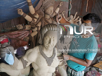 An artisan from Bangla Bazar sculpting a statue of Durga Puja Idol during the Preparations for Hindu Festival of Durga Puja are underway. On...