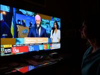 A woman watches New Democratic Party leader Jagmeet Singh speaking during a televised address on election night on CTV News.
Early election...