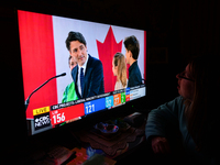A woman watches Liberal Party of Canada Leader Justin Trudeau speaking during a televised address on election night on CTV News.
Early elect...