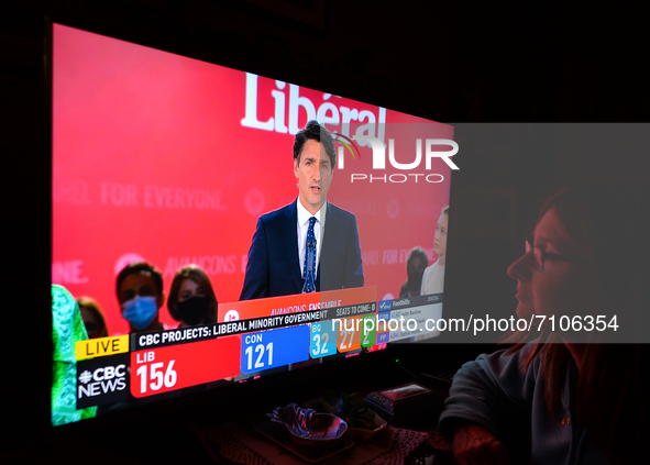 A woman watches Liberal Party of Canada Leader Justin Trudeau speaking during a televised address on election night on CTV News.
Early elect...