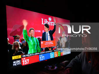 A woman watches Liberal Party of Canada Leader Justin Trudeau celebrating with his family during a televised election night on CTV News.
Ear...