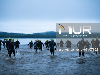 Athletes enter in the cold water, at Swedeman 2021 in Åre, Sweden (