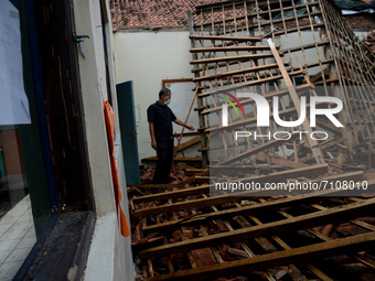 A man looks at the condition of the roof building on a class room that collapsed due to the weathered condition of the wood at primary schoo...