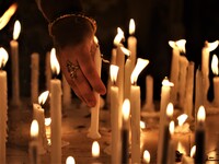Women light a candle during a celebration of Madhu Purnima or Honey full moon at an international Buddhist monastery in Dhaka, Bangladesh on...