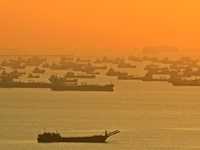 A general view of vessels anchored along the southern coast at sunrise on September 22, 2021 in Singapore.  (