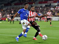  Oldham Athletic's Dylan Fage tussles with Tariqe Fosu of Brentford during the Carabao Cup match between Brentford and Oldham Athletic at th...