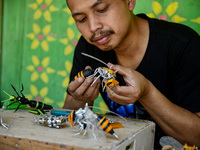 Yusuf (29) creating Transformers bee action figures in his home in Puncak, Bogor, West Java, Indonesia on September 22, 2021. Yusuf creates...