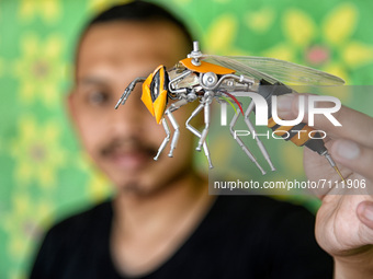 Yusuf (29) showing Transformers bee action figures in his home in Puncak, Bogor, West Java, Indonesia on September 22, 2021. Yusuf creates a...