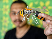 Yusuf (29) showing Transformers bee action figures in his home in Puncak, Bogor, West Java, Indonesia on September 22, 2021. Yusuf creates a...