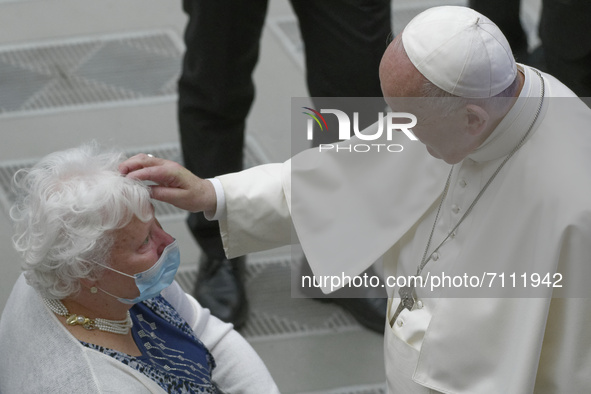 Pope Francis blesses a woman at the end of his weekly general audience in the Paul VI Hall at the Vatican, Wednesday, Sept. 22, 2021.  