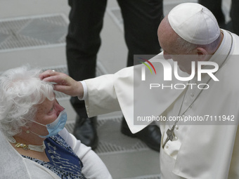 Pope Francis blesses a woman at the end of his weekly general audience in the Paul VI Hall at the Vatican, Wednesday, Sept. 22, 2021.  (