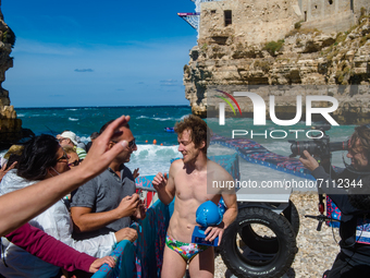 Divers greet the public asking for a photo in Polignano a Mare during the Red Bull Cliff Diving 2021 at Lama Monachile on September 22, 2021...