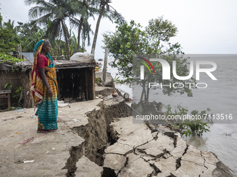 A women looks at The Padma River where she has lost her house by river erosion in Manikganj Bangladesh, on September 20, 2021. (