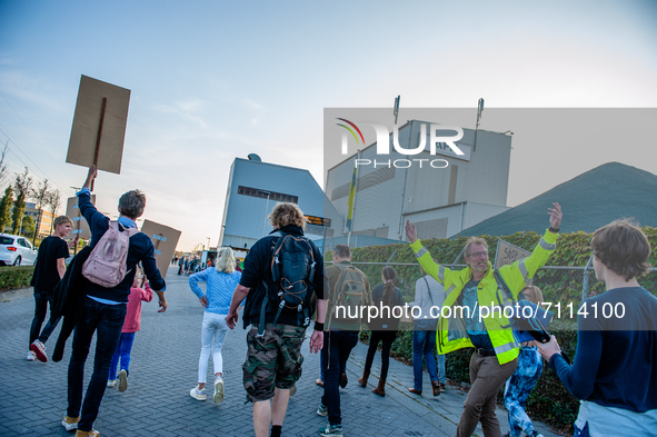 Local residents are walking to the to the factory with placards against it, during a demonstration against the APN asphalt plant, in Nijmege...