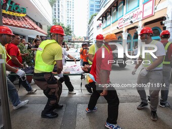 Libis, Quezon City Philippines - An injured man is rushed to an ambulance during the nationwide earthquake drill in Libis, Quezon City on Th...