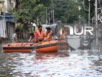 Disaster management team in a boat through the waterlogged area during a rescue operation after heavy rain on September 23, 2021 in Kolkata,...