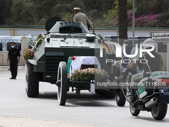 The coffin of the former head of state and president of the National Assembly, Abdelkader Bensalah, by a military vehicle towards the cemete...