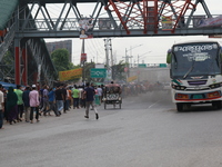 Workers of Sinha garment factory break a bus during a protest to demand for their three-month due wages at Kanchpur in Narayangang, Banglade...