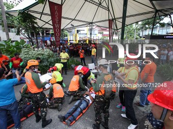 Libis, Quezon City Philippines - Injured people are assisted during the nationwide earthquake drill in Libis, Quezon City on Thursday, July...
