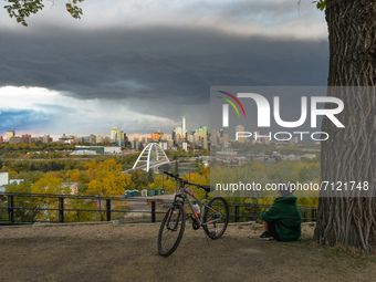 A young woman observes approaching storm over downtown Edmonton, Alberta.
On Wednesday, 22 September 2021, in Edmonton, Alberta, Canada. (