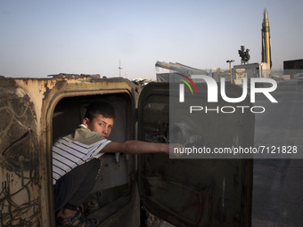 An Iranian young boy plays with a military personnel carrier while visiting a war exhibition which is held and organized by the Islamic Revo...