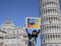 People attending the 24th September global climate strike organized by the Friday For Future movement in front of the leaning tower in Pisa,...