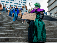 A drag queen is walking down the stairs with a placard in support of the climate, during the Global Climate Strike organized in Utrecht, on...