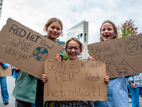 A group of female students are holding placards in support of the planet, during the Global Climate Strike organized in Utrecht, on Septembe...