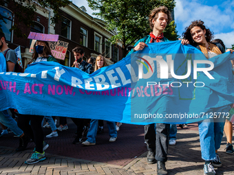 A group from XR University is holding a big banner, during the Global Climate Strike organized in Utrecht, on September 24th, 2021. (