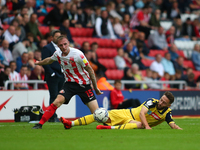  Sunderland's Carl Winchester is tackled by Bolton Wanderer's Josh Sheehan during the Sky Bet League 1 match between Sunderland and Bolton W...