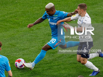 Malcom (C) of Zenit vies for the ball with Denis Yakuba of Krylia Sovetov during the Russian Premier League match between FC Zenit Saint Pet...