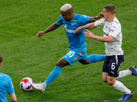 Malcom (C) of Zenit vies for the ball with Denis Yakuba of Krylia Sovetov during the Russian Premier League match between FC Zenit Saint Pet...