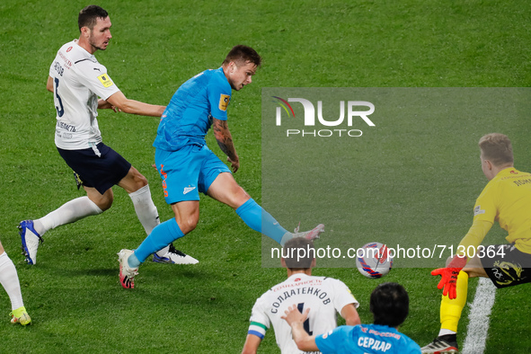 Danil Krugovoy (C) of Zenit shoots on goal as Nikita Chernov (L) and Ivan Lomaev (R) of Krylia Sovetov defend during the Russian Premier Lea...