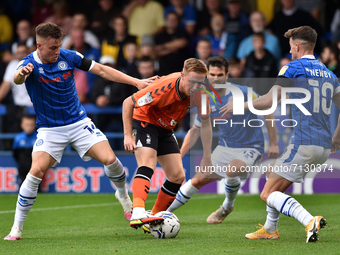 Oldham Athletic's Davis Keillor-Dunn tussles with George Broadbent of Rochdale AFC and Alex Newby of Rochdale AFC during the Sky Bet League...