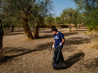A volunteer from the Terrae Association cleans up the green lung of the city Lama Martina during the National Plastic Free Day in Molfetta o...