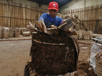 Traders sell tobacco products from farmers to distributors at a tobacco warehouse in Temanggung on September, 27, 2021. The tobacco industry...