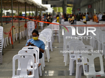 People are waiting to be vaccinated against COVID-19 at a vaccination centre in Bangkok, set up at Bang Sue central railway station in Bangk...