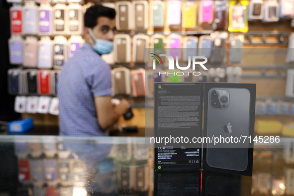 A Palestinian venedor displays Apple's new iPhone13 at a mobile phone store in Gaza City on September 28, 2021. 
 