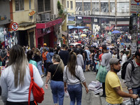 People walk in downtown of Sao Paulo, Brazil, on September 28, 2021 amid the Covid-19 pandemic. (