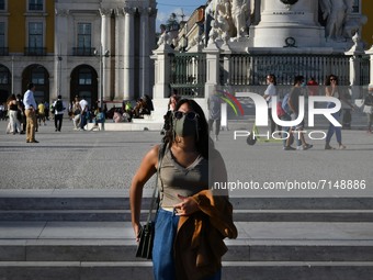 A woman wearing protective mask walks around Praça de Comercio in the Baixa district, Lisbon, Portugal on September 27, 2021. Portugal recor...