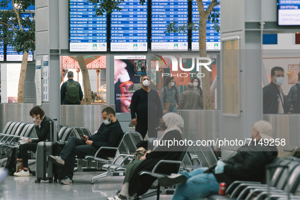 people sit and wait to get check in a at Duessldorf airport, Germany on September 29, 2021 