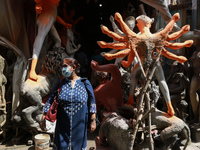 Hindu women devotees warning protective facemask against the coronavirus in front of Hindu Goddess Durga idol at Kumartuli, the potter's vil...