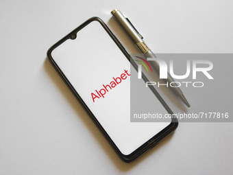 In this photo illustration an Alphabet logo is display on a smartphone screen and a pencil in Athens, Greece on October 4, 2021. (