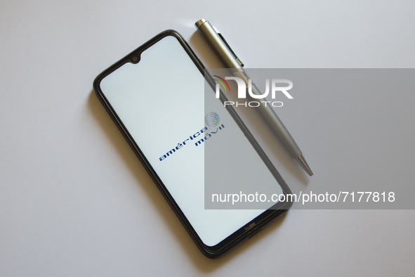 In this photo illustration an America Movil logo is display on a smartphone screen and a pencil in Athens, Greece on October 4, 2021. 